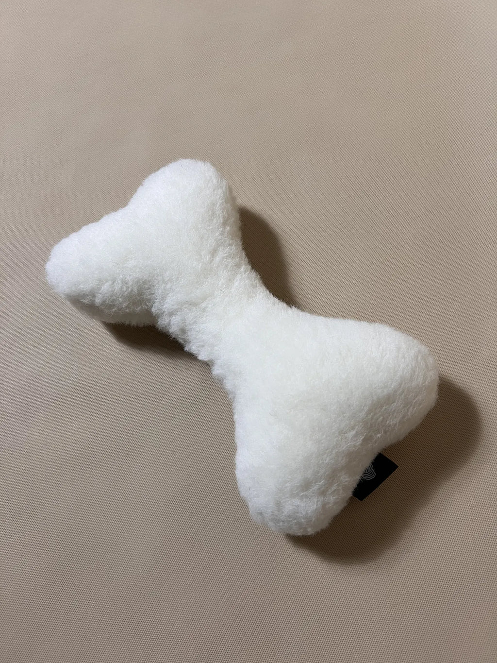 Soft cashmere bone-shaped pet pillow designed for comfortable rest for cats and small dogs.