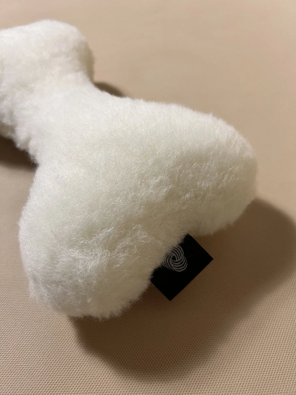 Soft cashmere bone-shaped pet pillow with plush, natural cashmere fabric for comfortable pet rest.