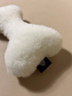 Soft cashmere bone-shaped pet pillow with plush, natural cashmere fabric for comfortable pet rest.