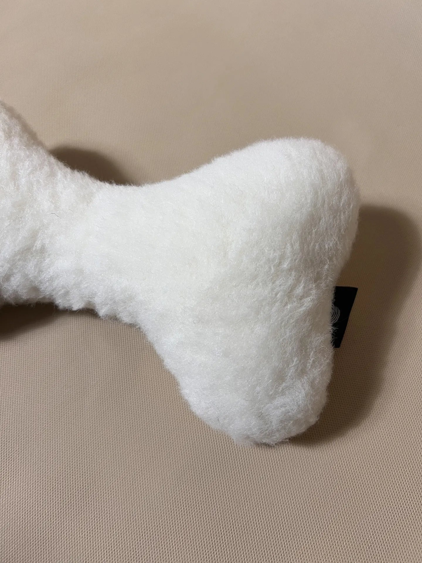 Soft cashmere bone pet pillow with plush fabric and comfortable design for small pets, ideal for resting.