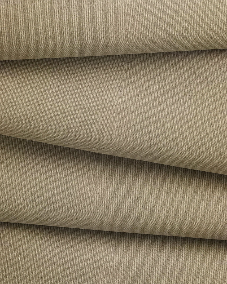 Close-up of beige cotton canvas fabric with a subtle texture.