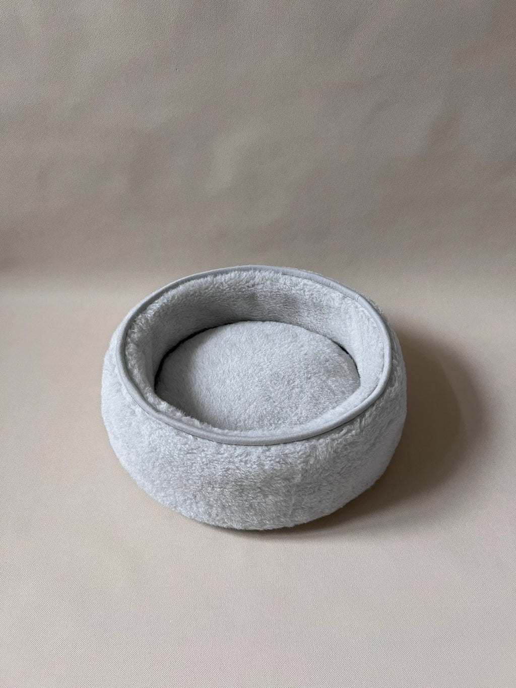Soft wool alpaca pet bed, plush with a neutral color, ideal for small pets.