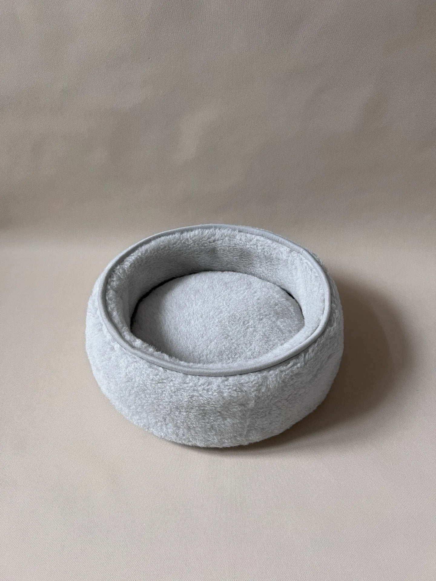 Soft wool alpaca pet bed, plush with a neutral color, ideal for small pets.