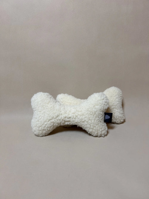Soft wool bone-shaped pet pillow, with boucle loop texture, plush and comfortable for dogs or cats.