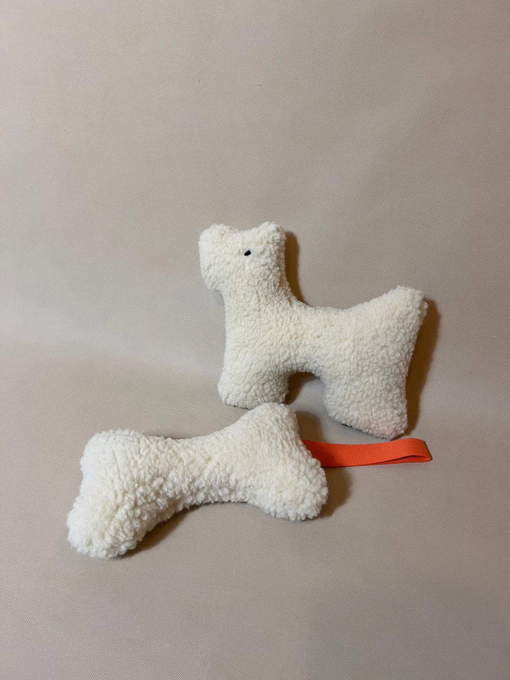 Wool Bone Pet Pillow showing a plush pet pillow in wool with a bone shape toy for pets.