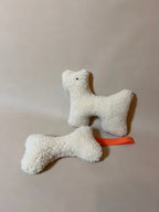 Wool Bone Pet Pillow showing a plush pet pillow in wool with a bone shape toy for pets.