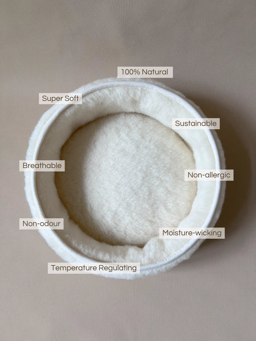 Soft wool and cashmere pet bed with plush fabric.