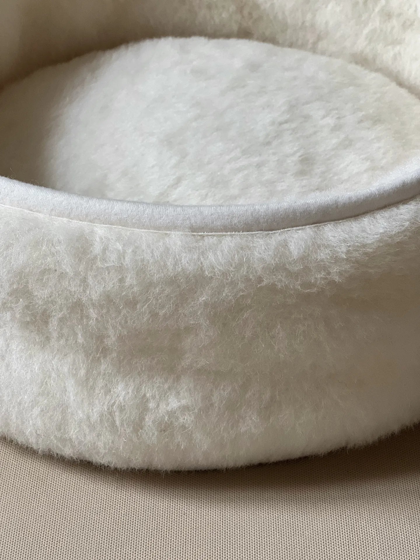 Soft wool and cashmere pet bed for small to medium pets, with a comfortable, cushioned surface.