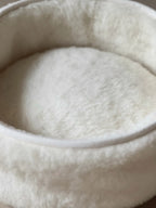 Soft wool and cashmere pet bed featuring plush fabric and unique design.