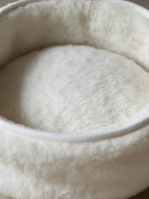 Soft wool and cashmere pet bed featuring plush fabric and unique design.