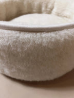 Soft wool and cashmere pet bed with plush, textural fabric and cushioned design for all pets.