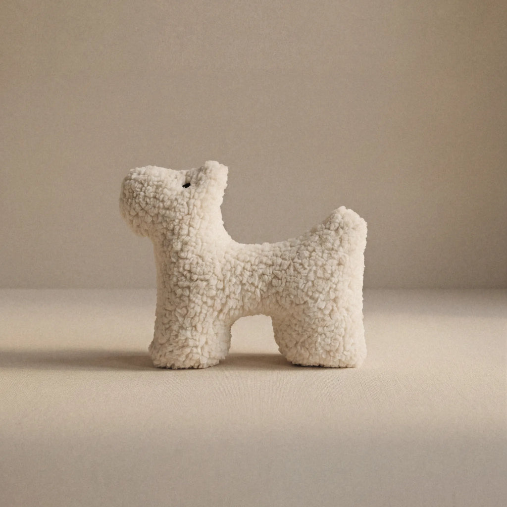 A small wool plush pet toy featuring a bouclé loop textured material, standing on a neutral beige background.