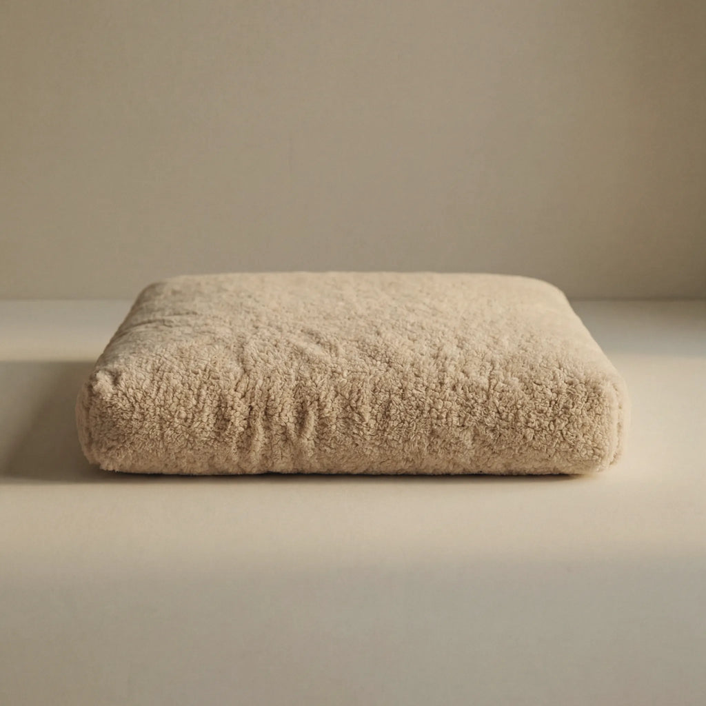 Beige 'Wool Lounge Bouclé Pet Bed' on a neutral background.