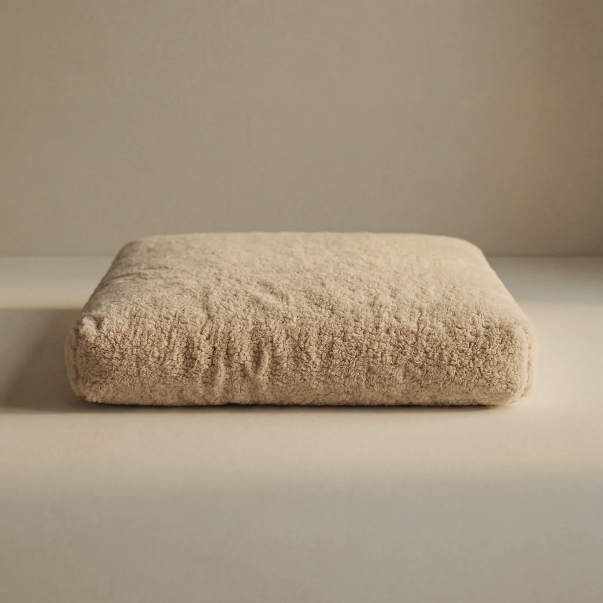Beige 'Wool Lounge Bouclé Pet Bed' on a neutral background.
