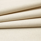 Close-up of cotton canvas fabric with a visible woven texture and subtle warm beige undertones.