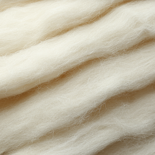 Close-up of beige wool fibers.