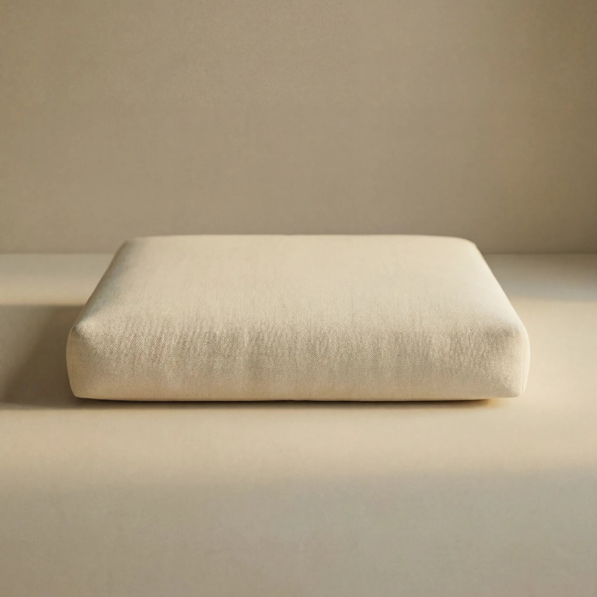 A cream inner pillow of 'Wool Lounge Bouclé Pet Bed' against a matching beige background. 